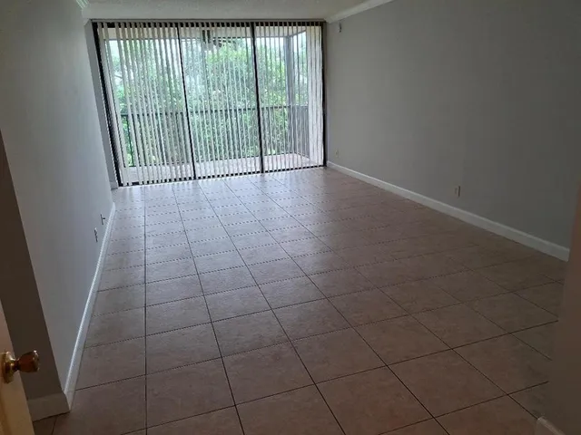 en empty room with sliding door and mountain view