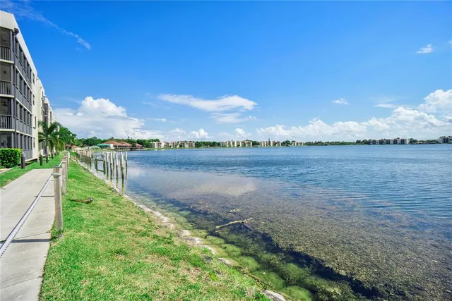 a view of a lake with table and chairs