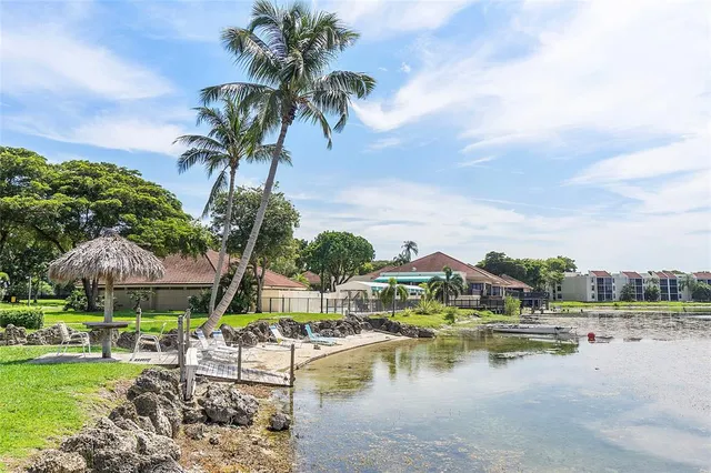 a view of swimming pool with outdoor seating and lake