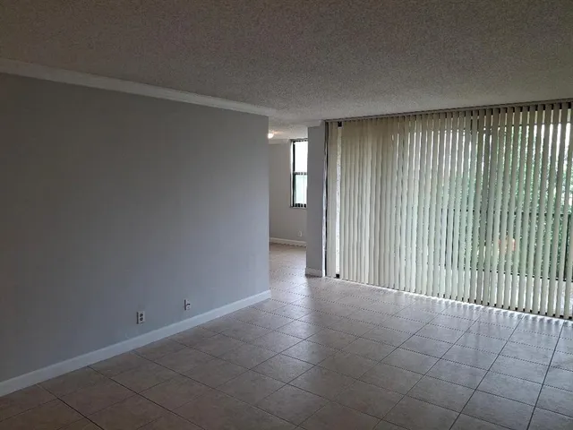 a view of a livingroom with an empty space and a window