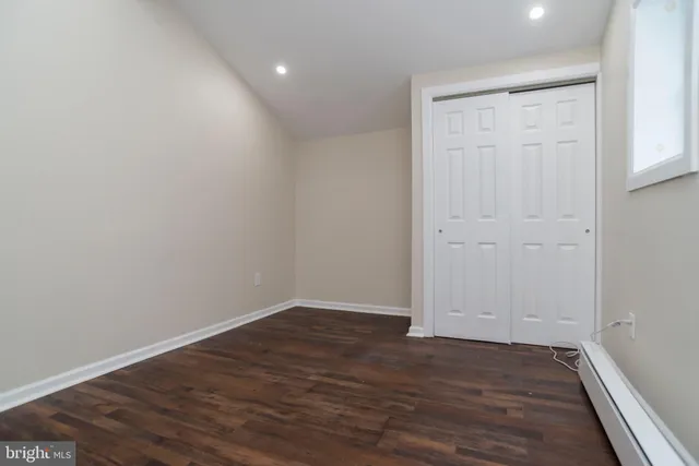a view of room with wooden floor