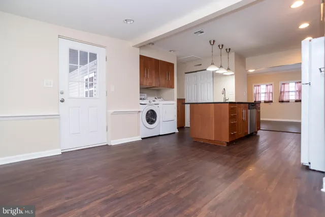 a view of a kitchen with a sink and a refrigerator