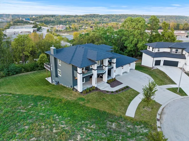 a workspace with furniture a chandelier and wooden floor