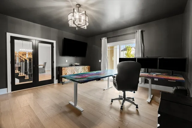 a kitchen with stainless steel appliances kitchen island granite countertop a table chairs sink and cabinets