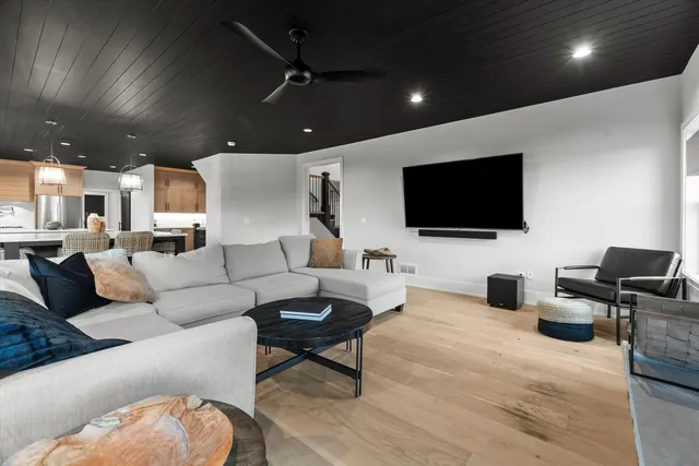 a kitchen with stainless steel appliances kitchen island granite countertop a sink a oven and a large window