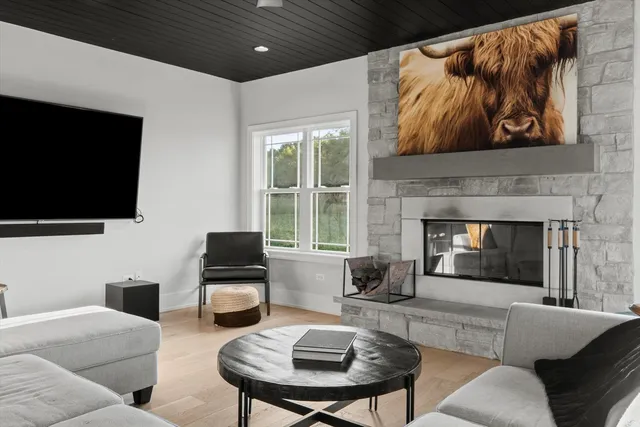 a large white kitchen with stainless steel appliances granite countertop a stove a refrigerator and white cabinets