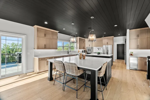 a view of a hallway with wooden floor and stairs