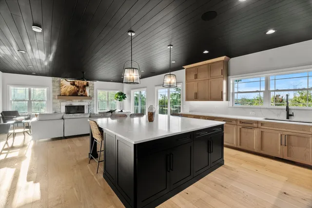 a bedroom with a bed a couch and a chandelier