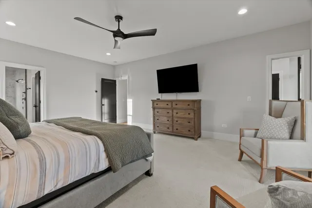 a en suite bathroom with a granite countertop sink and a mirror