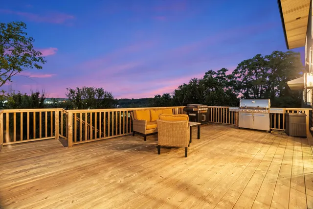 a front view of a house with yard and green space