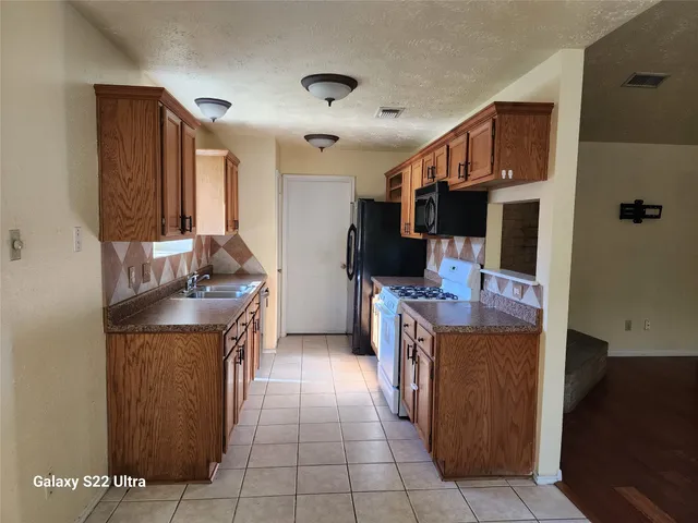 a kitchen with kitchen island cabinets and counter space