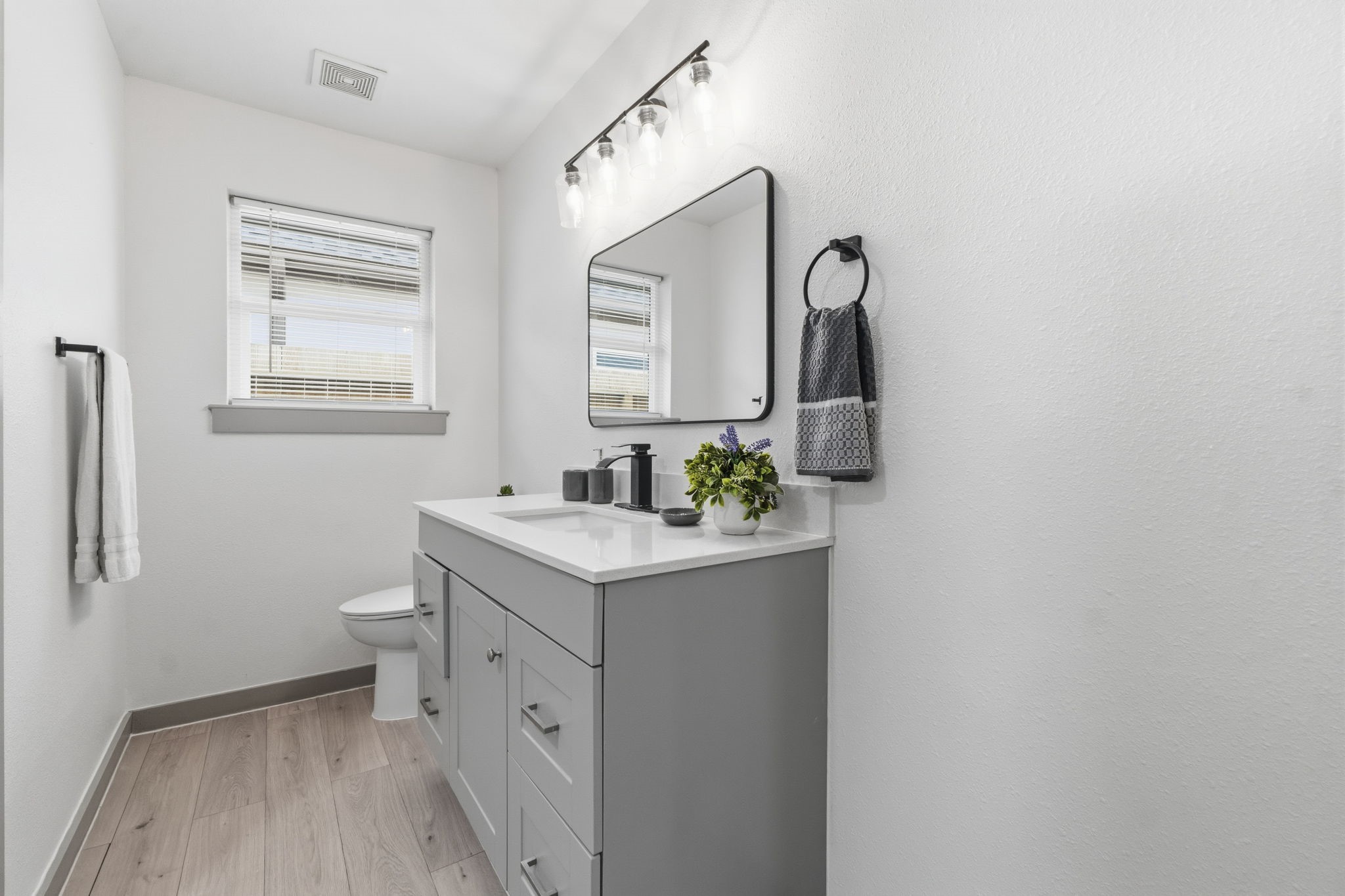 14850 Coaltown Road Willis, TX 77378 - Photo 17 of 41 Updated full bathroom featuring a modern vanity, stylish fixtures, contemporary lighting, and neutral finishes.