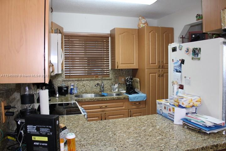 Hialeah Hialeah, FL 33018 - Photo 11 of 18 a kitchen with stainless steel appliances kitchen island granite countertop a sink and a refrigerator