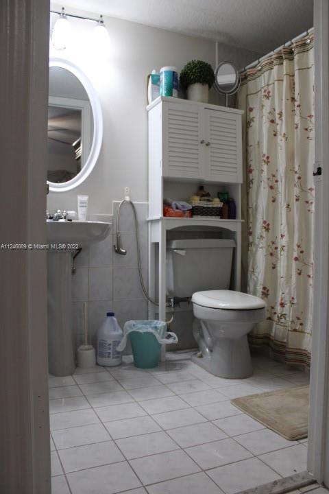Hialeah Hialeah, FL 33018 - Photo 15 of 18 a bathroom with a toilet a sink and mirror