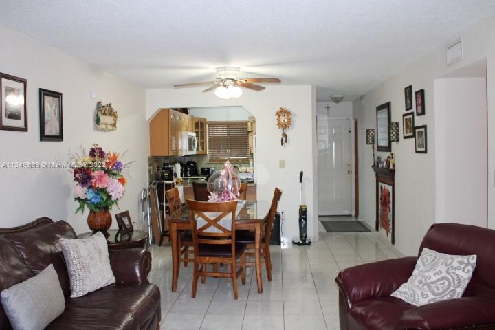Hialeah Hialeah, FL 33018 - Photo 9 of 18 a living room with furniture and a chandelier