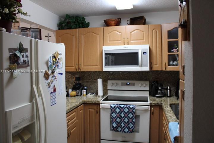 Hialeah Hialeah, FL 33018 - Photo 10 of 18 a kitchen with stainless steel appliances granite countertop a refrigerator and a stove top oven