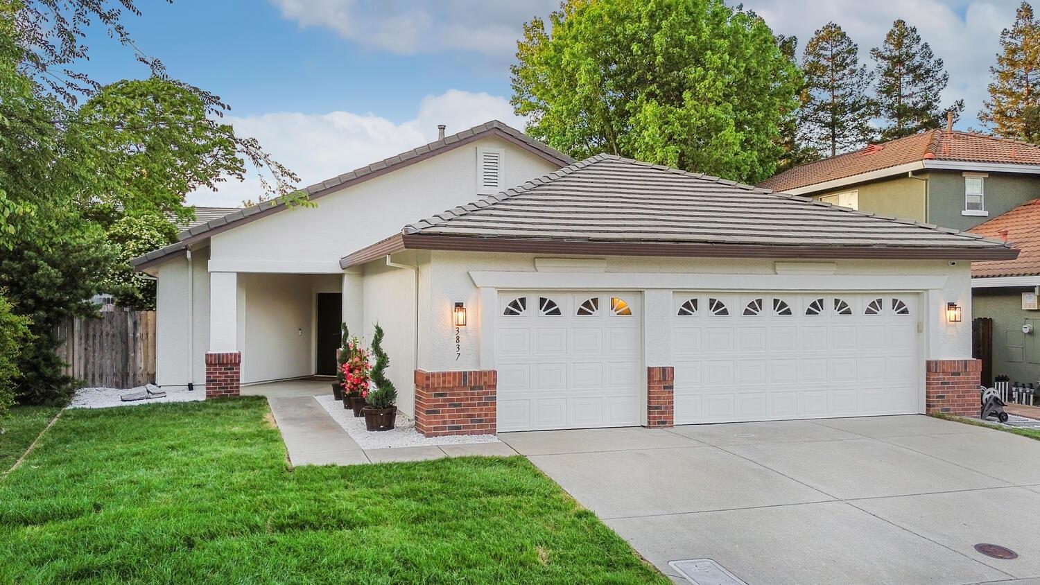 a front view of a house with a yard and garage