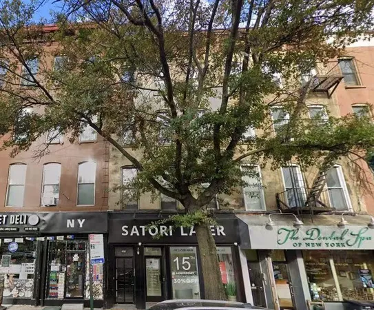 a front view of a building with trees