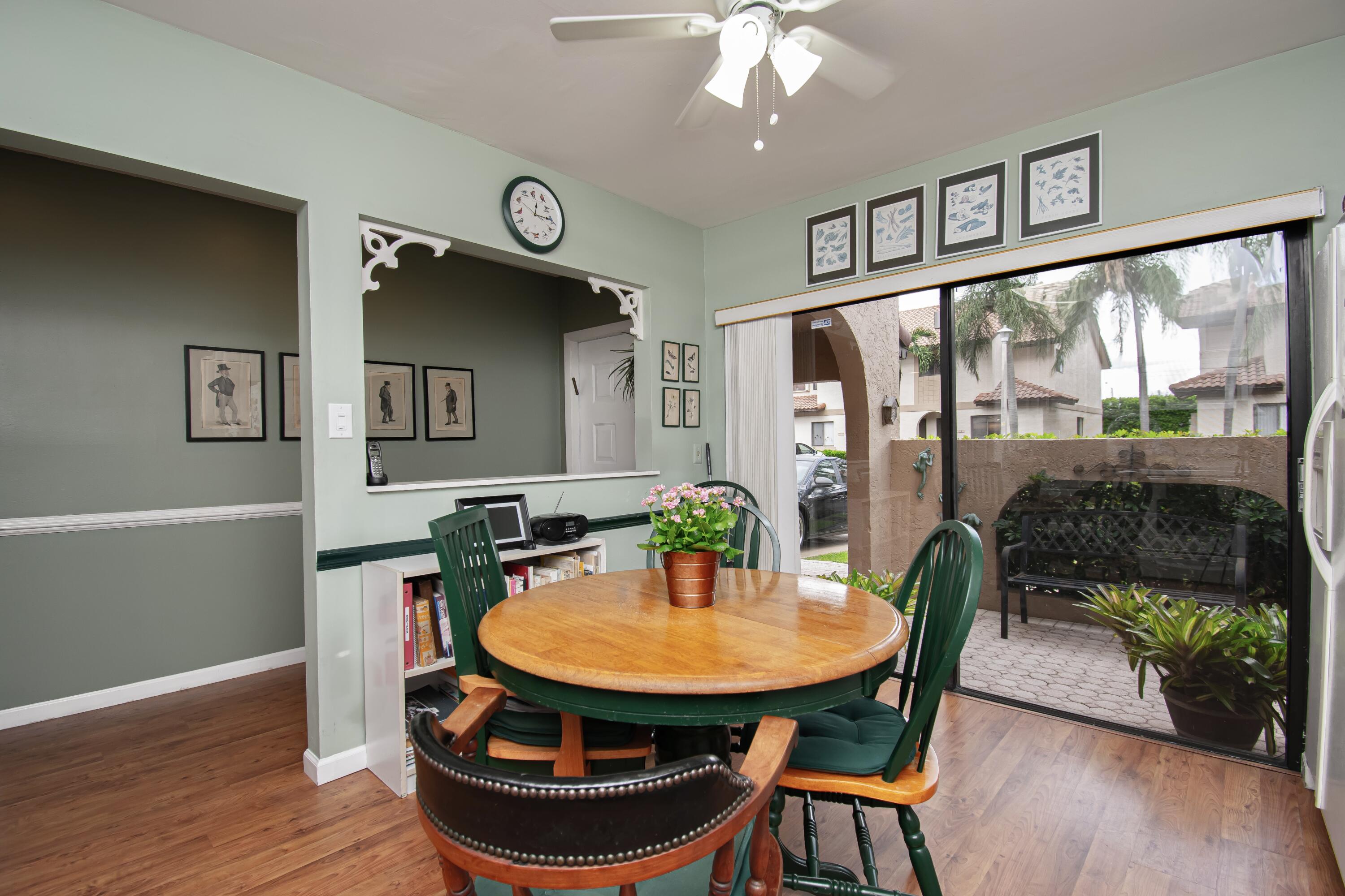22066 Las Brisas Circle Boca Raton, FL 33433 - Photo 11 of 45 a view of a dining room with furniture window and wooden floor