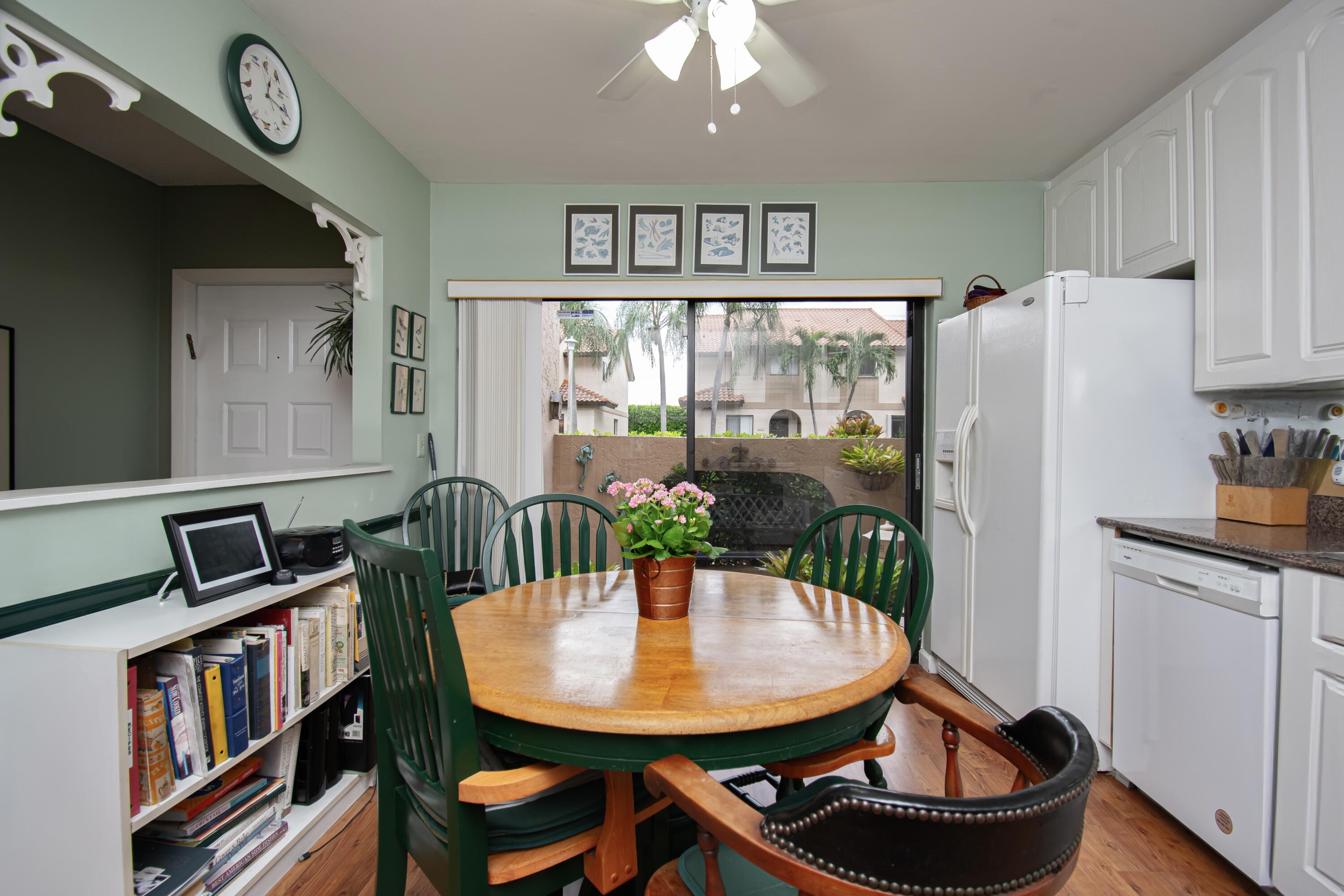 22066 Las Brisas Circle Boca Raton, FL 33433 - Photo 12 of 45 a view of a dining room with furniture window and wooden floor