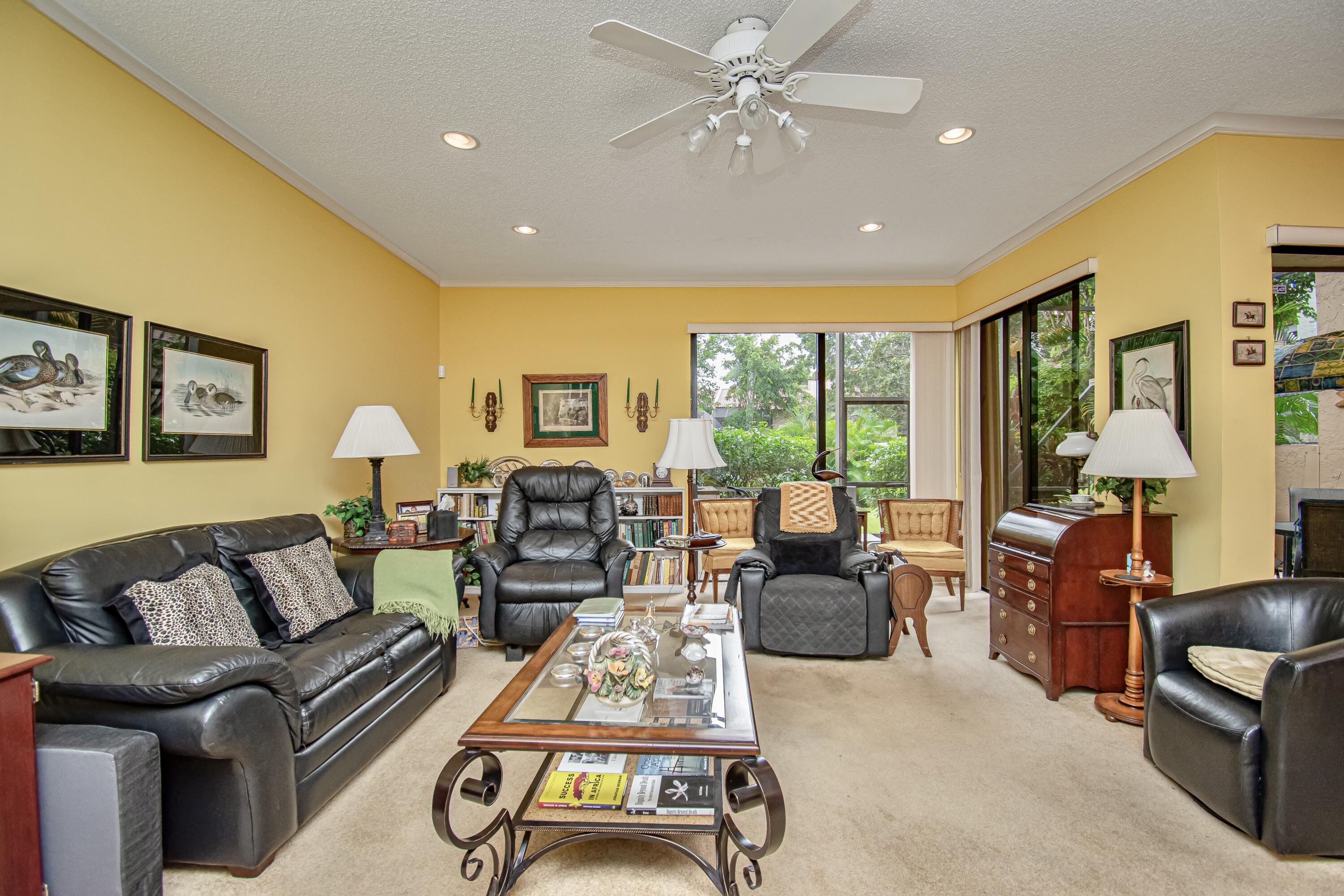 22066 Las Brisas Circle Boca Raton, FL 33433 - Photo 16 of 45 a living room with furniture ceiling fan and a large window