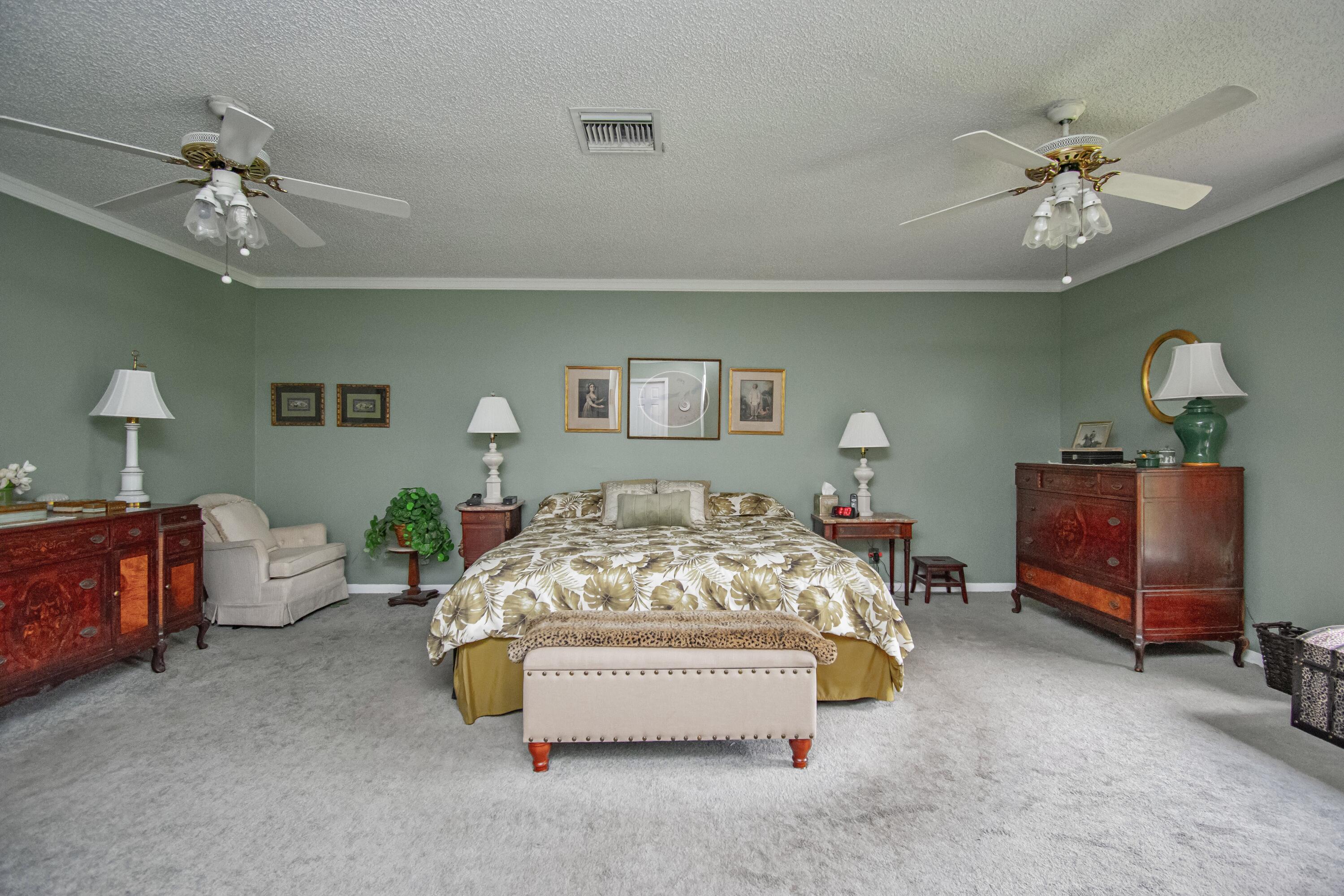 22066 Las Brisas Circle Boca Raton, FL 33433 - Photo 22 of 45 a bedroom with furniture and a chandelier