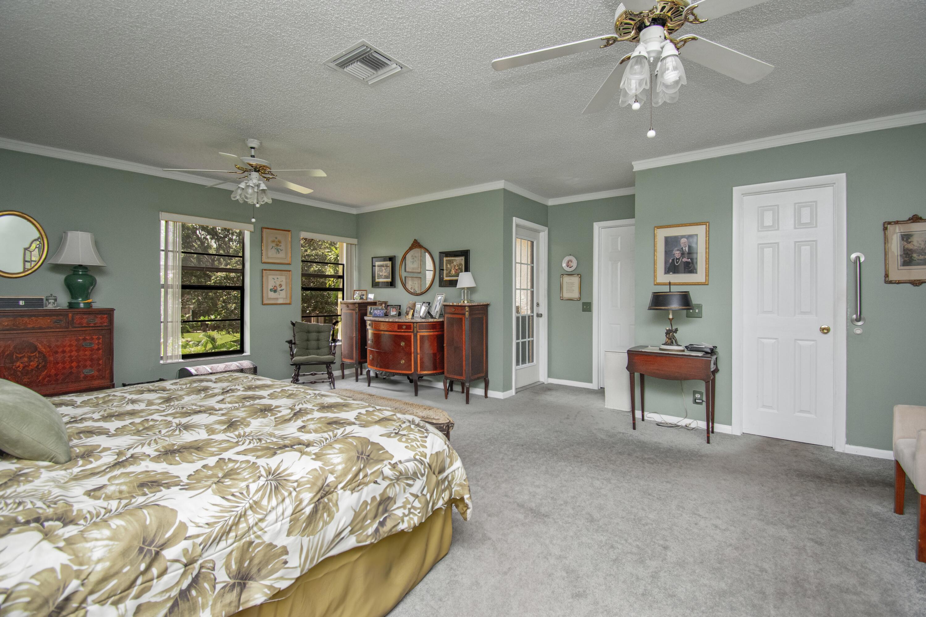 22066 Las Brisas Circle Boca Raton, FL 33433 - Photo 23 of 45 a bed room with a bed and a chair