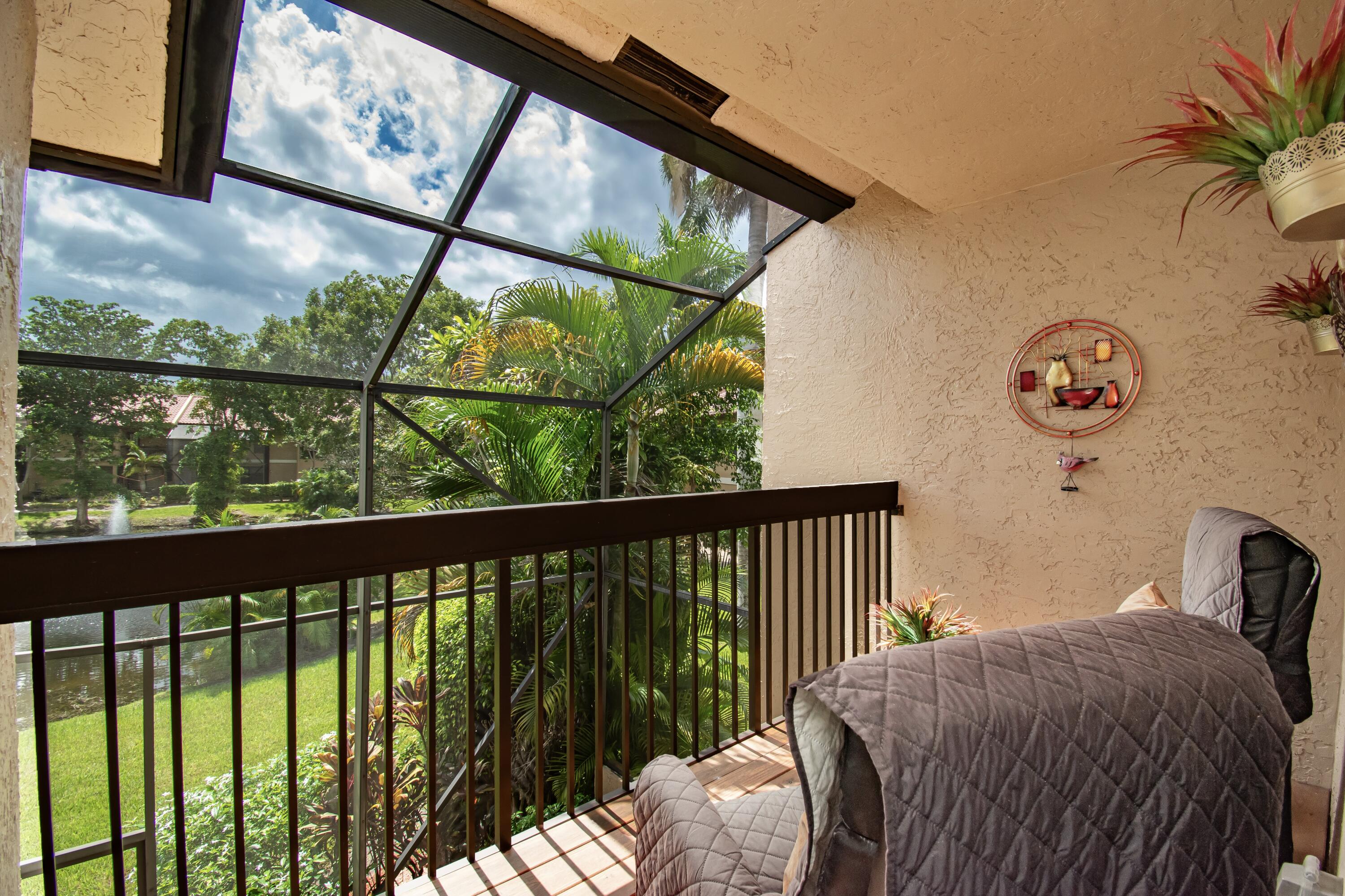 22066 Las Brisas Circle Boca Raton, FL 33433 - Photo 25 of 45 a bed sitting in a bedroom next to a window