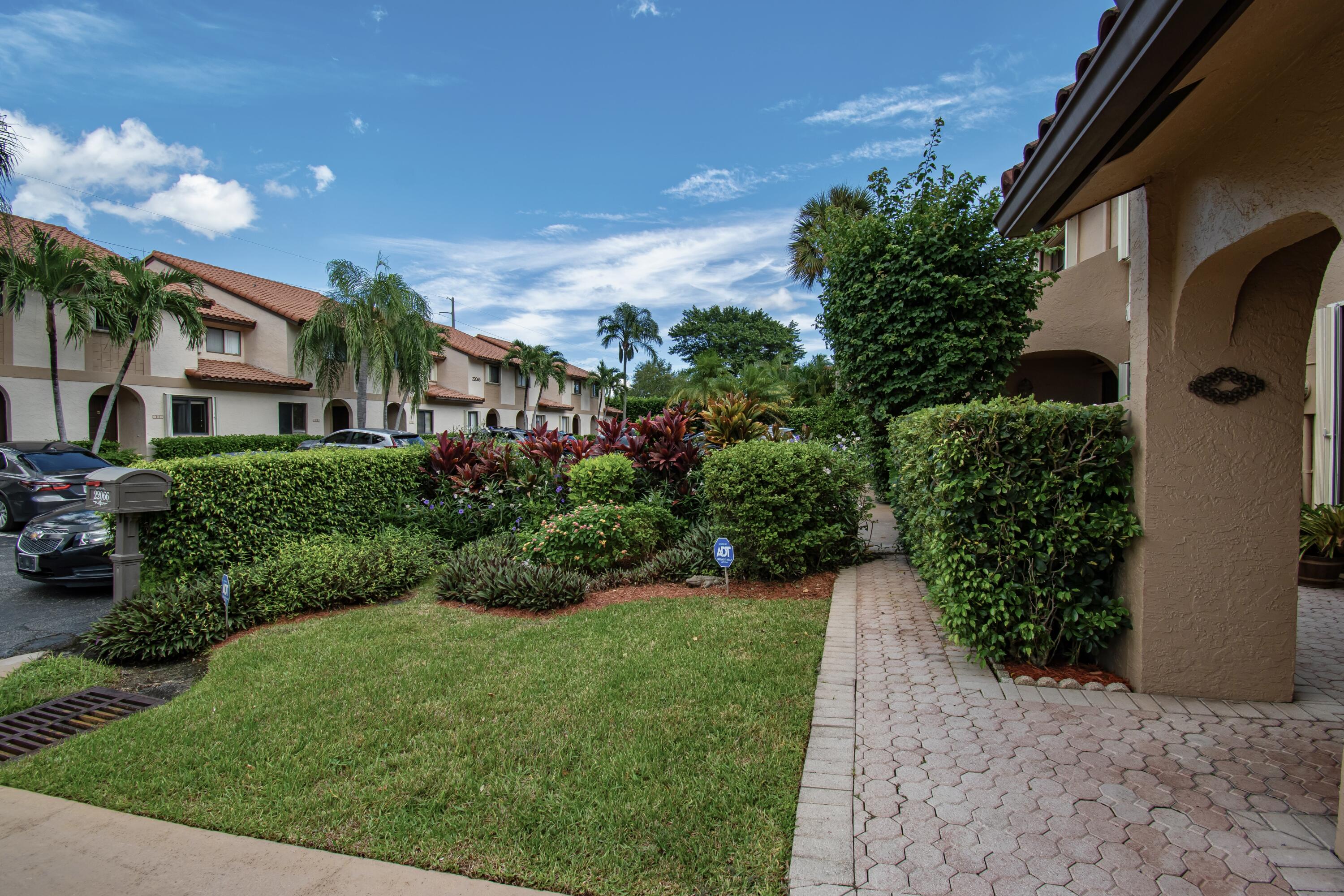 22066 Las Brisas Circle Boca Raton, FL 33433 - Photo 3 of 45 a view of a garden with a building in the background