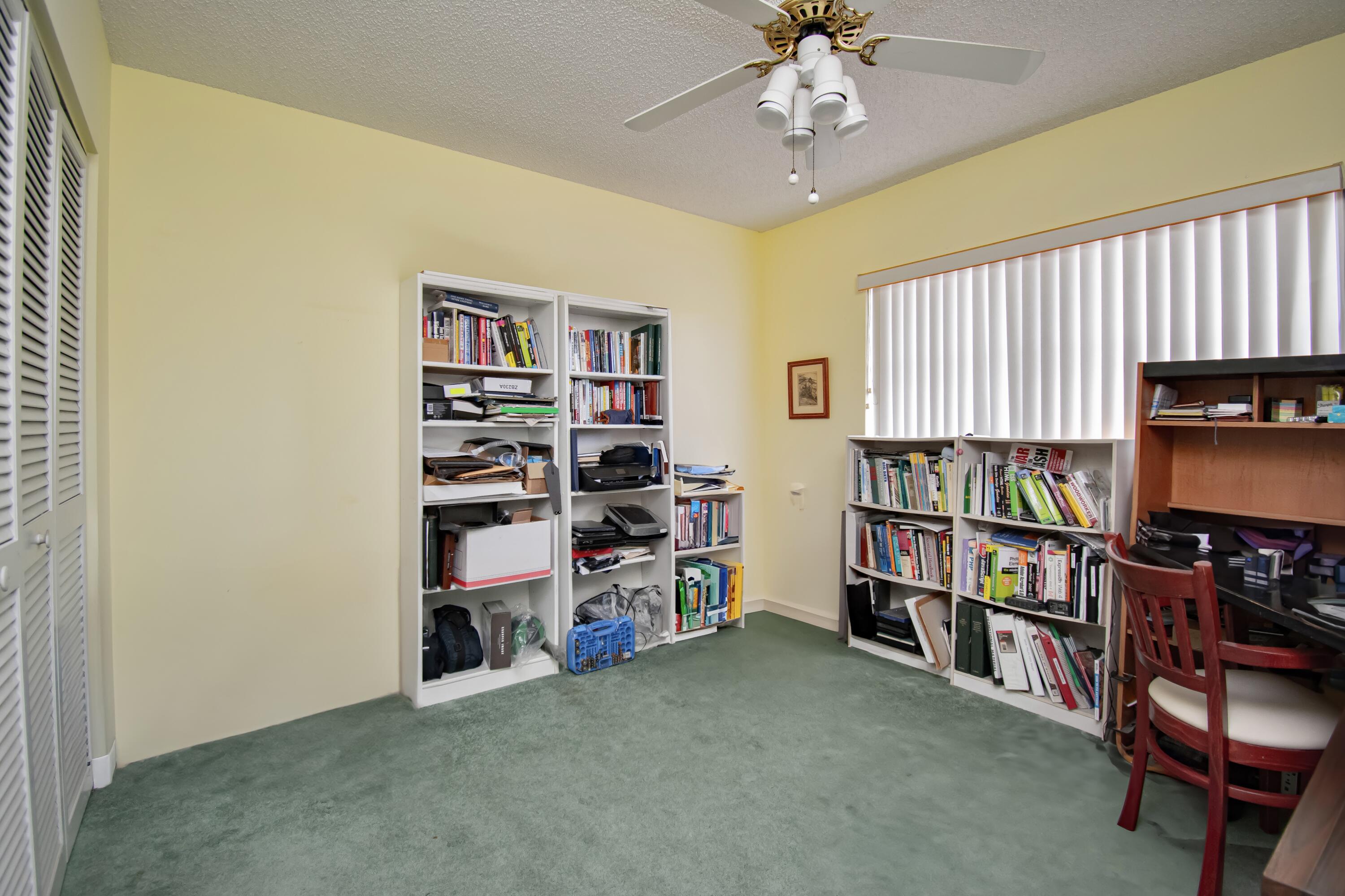 22066 Las Brisas Circle Boca Raton, FL 33433 - Photo 34 of 45 a room with furniture and a book shelf