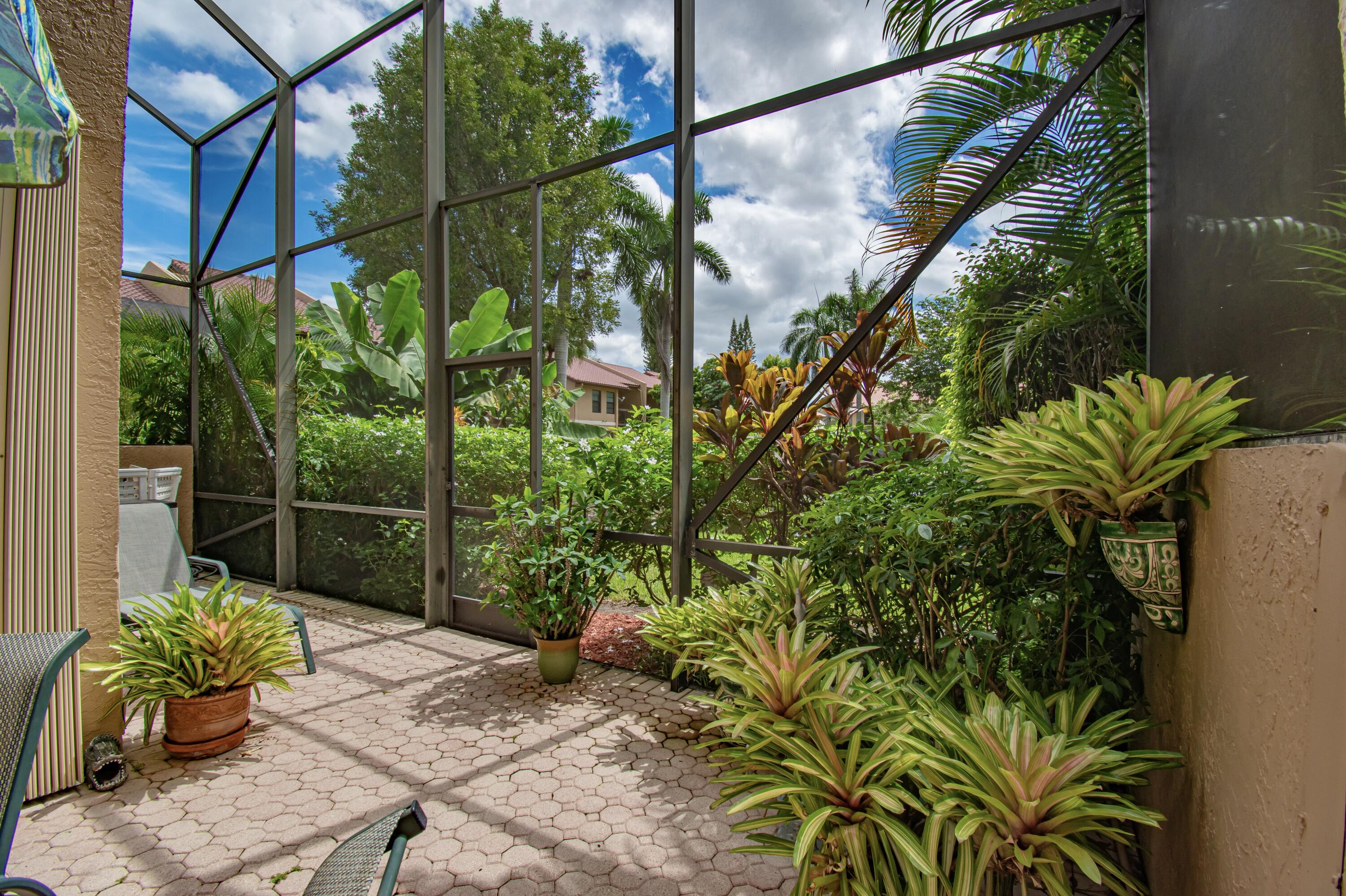 22066 Las Brisas Circle Boca Raton, FL 33433 - Photo 35 of 45 a backyard of a house with table and chairs potted plants