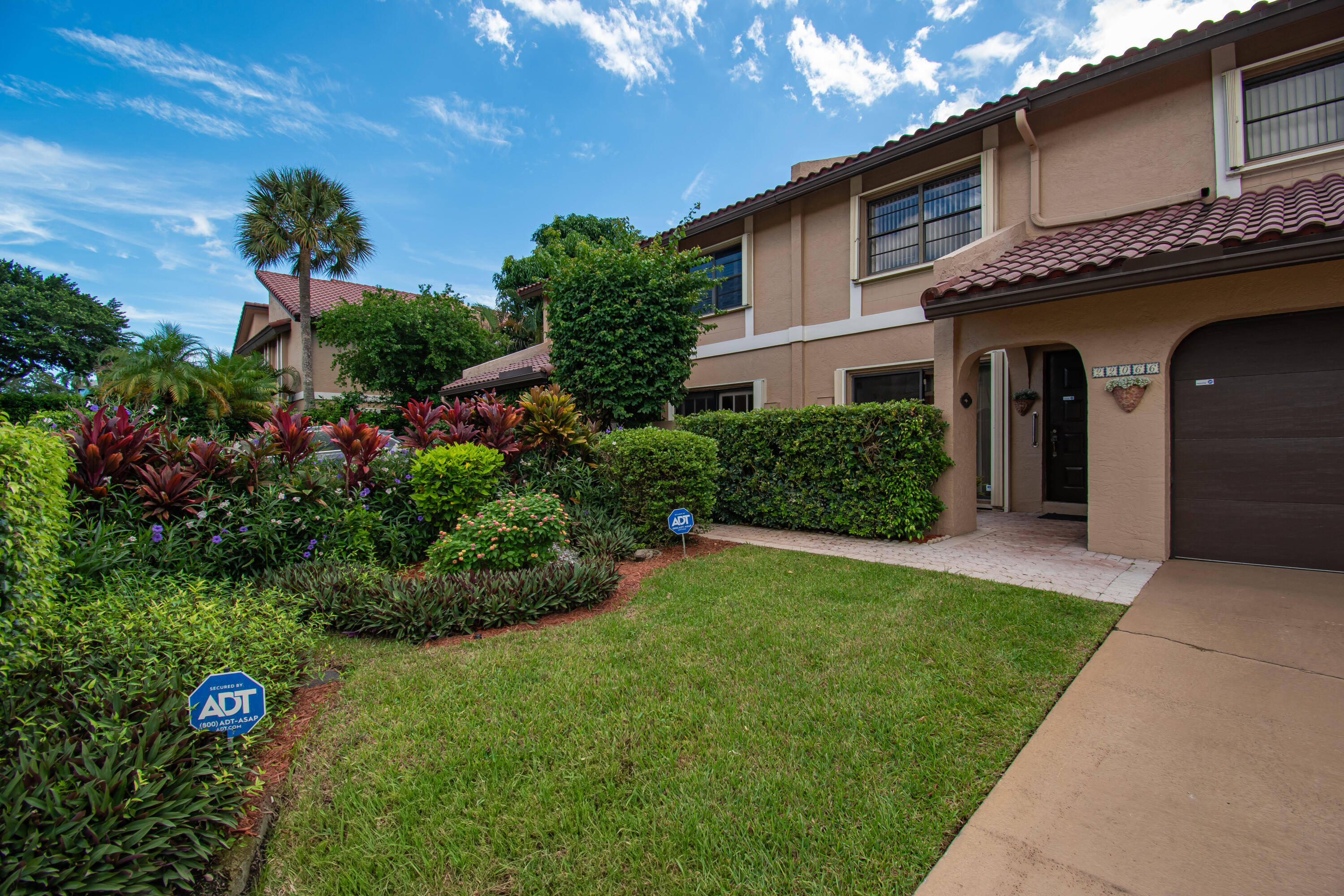 22066 Las Brisas Circle Boca Raton, FL 33433 - Photo 4 of 45 a front view of a house with a yard