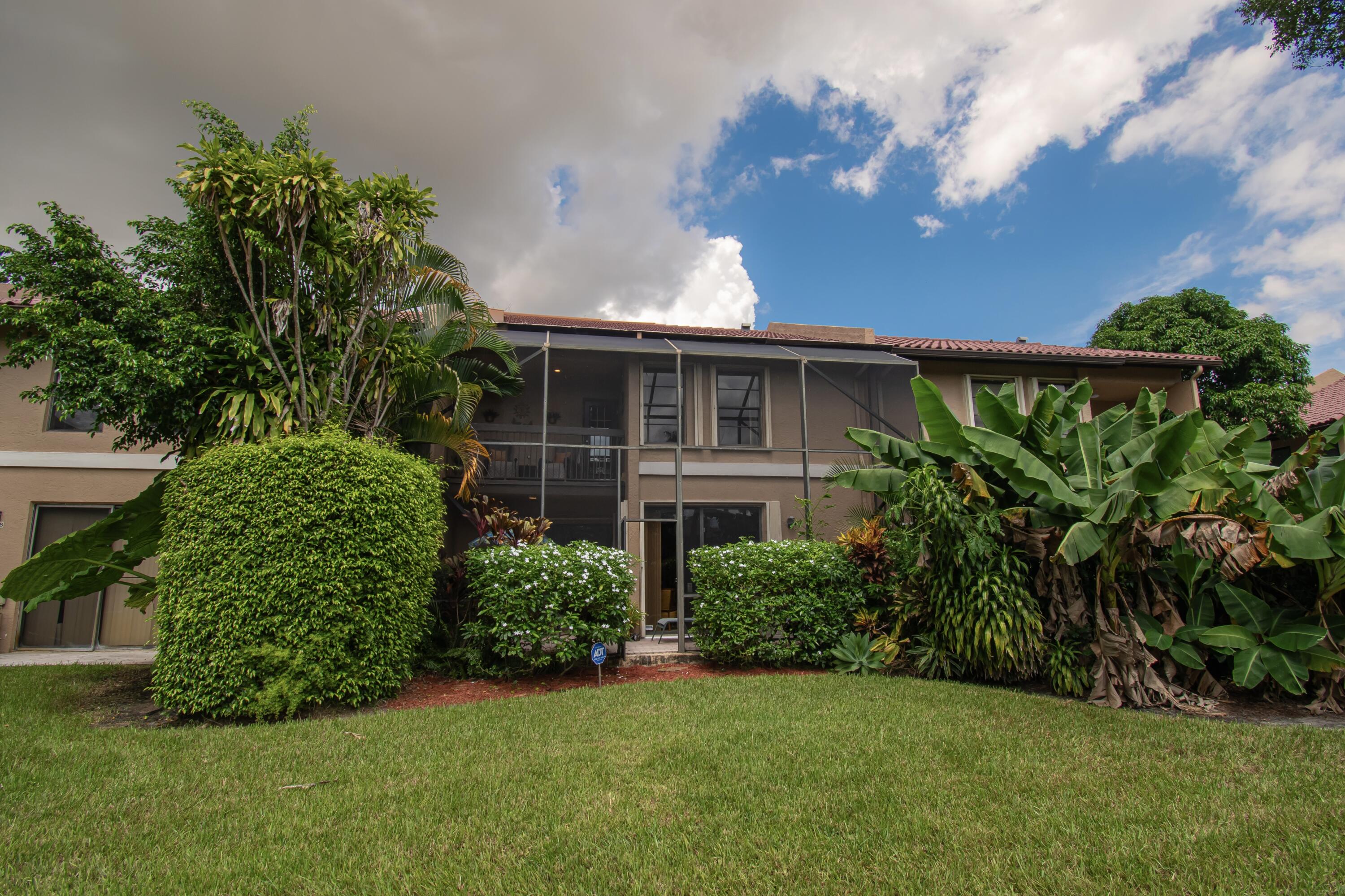 22066 Las Brisas Circle Boca Raton, FL 33433 - Photo 44 of 45 a front view of a house with a garden