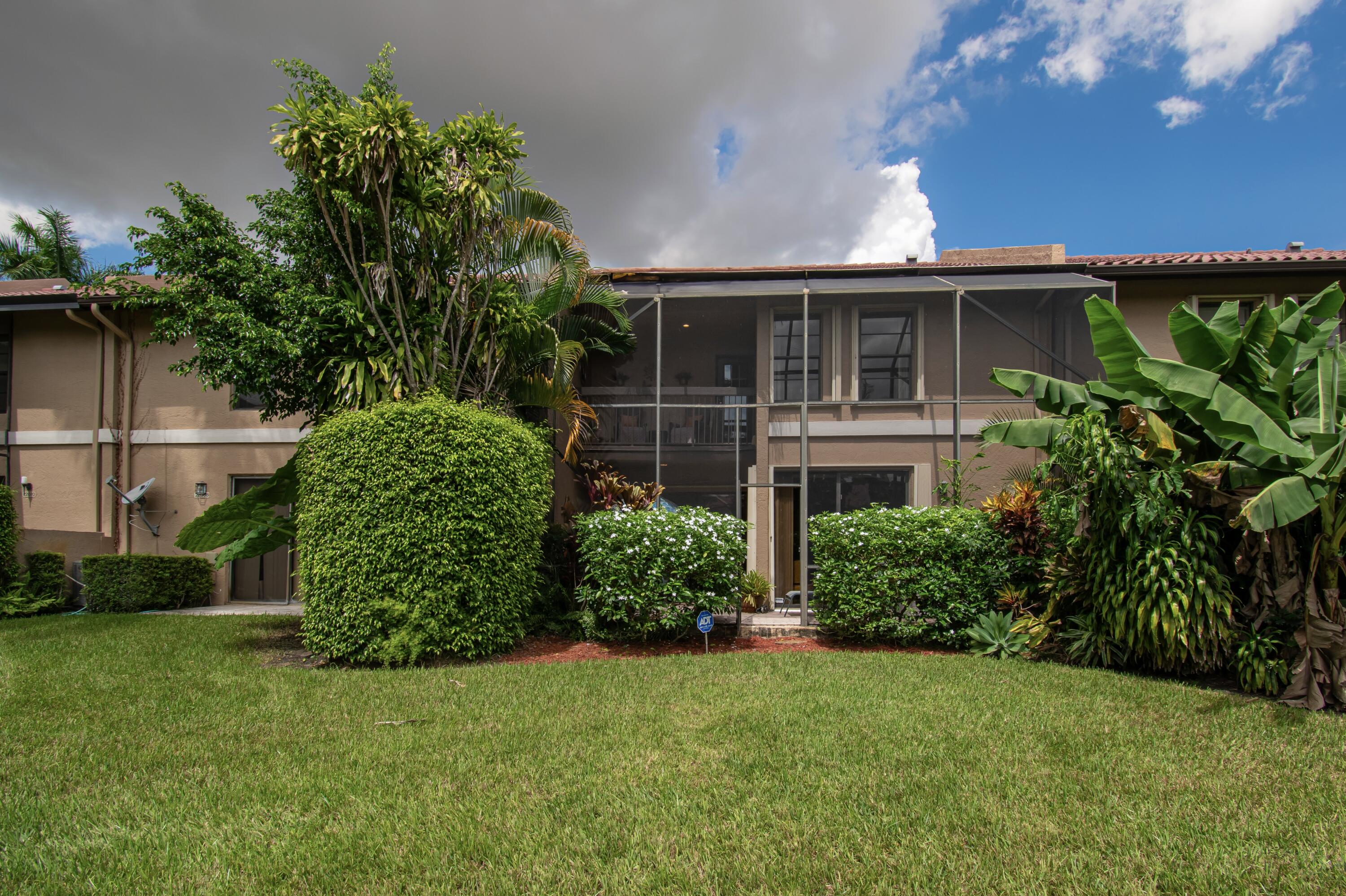 22066 Las Brisas Circle Boca Raton, FL 33433 - Photo 45 of 45 a front view of a house with a garden