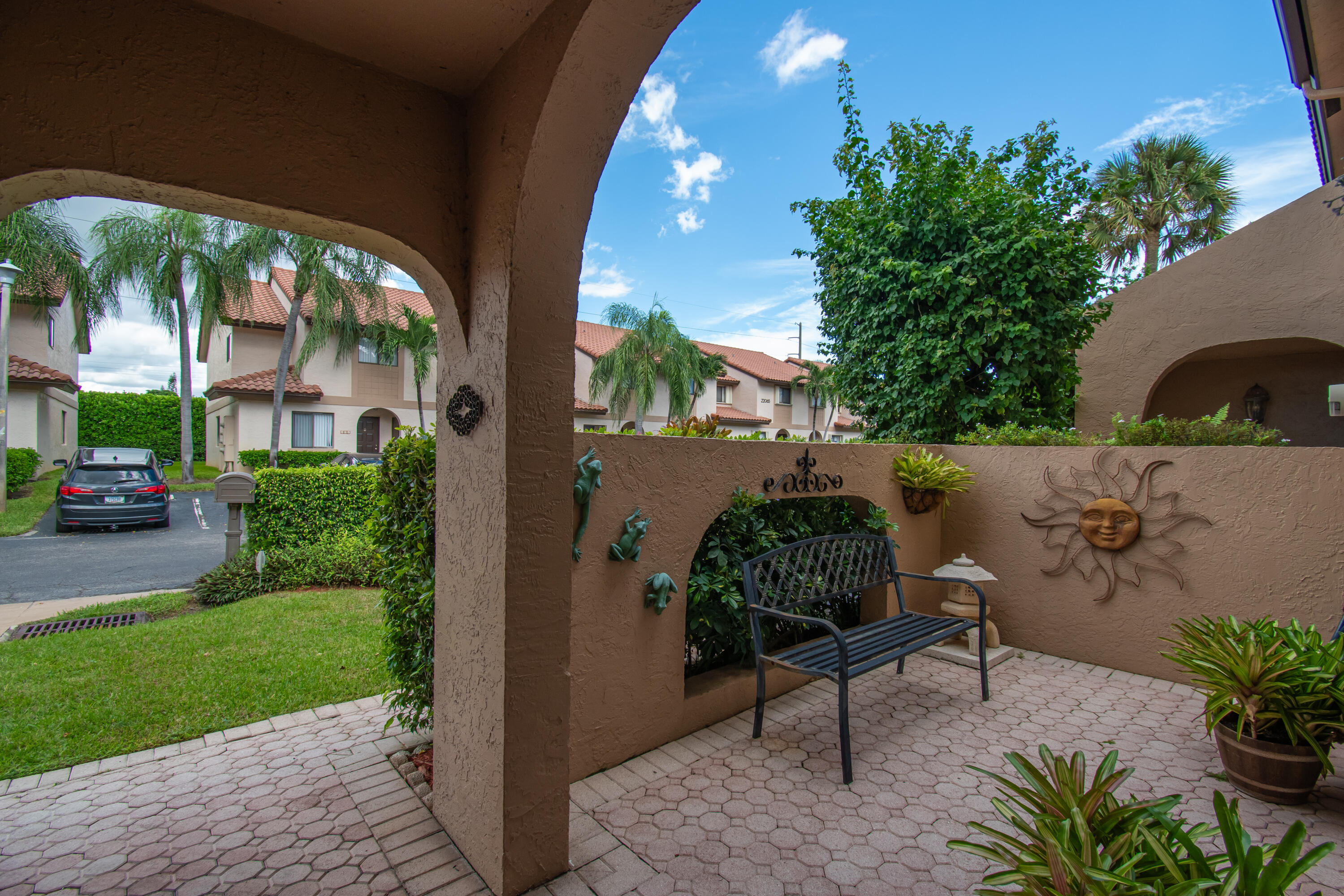 22066 Las Brisas Circle Boca Raton, FL 33433 - Photo 6 of 45 a backyard of a house with a garden and outdoor seating
