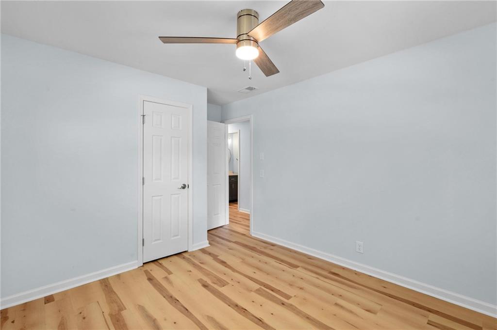 1745 Rockbridge Road Northwest Conyers, GA 30012 - Photo 19 of 32 a view of empty room with wooden floor