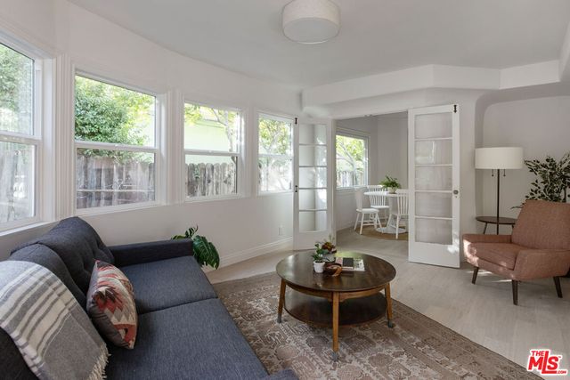 a bedroom with a bed lamp closet and window