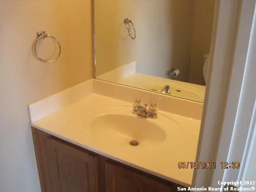 a bathroom with a tub sink and vanity