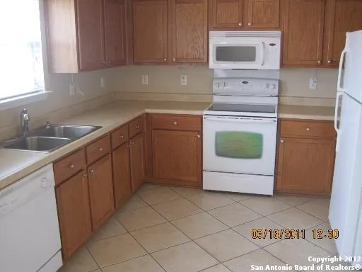 a kitchen with a sink a stove and cabinets