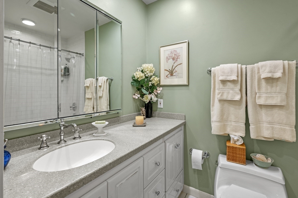9 Skinner's Path, Unit 9 Marblehead, MA 01945 - Photo 15 of 23 a bathroom with a granite countertop sink and a mirror