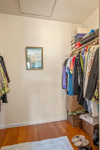 a view of walk in closet with clothes