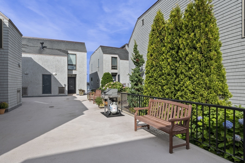 9 Skinner's Path, Unit 9 Marblehead, MA 01945 - Photo 21 of 23 a view of a chair and tables in the patio