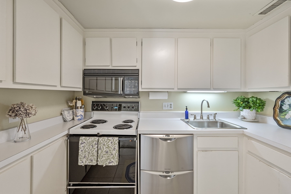 9 Skinner's Path, Unit 9 Marblehead, MA 01945 - Photo 3 of 23 a kitchen with appliances a sink and cabinets