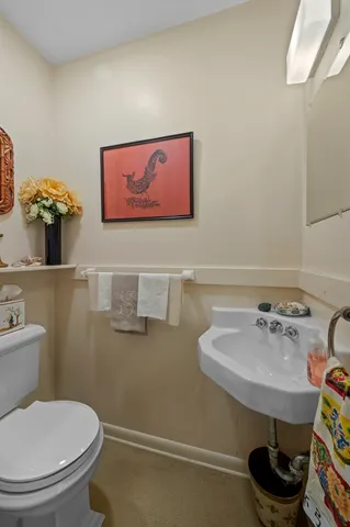 a bathroom with a toilet sink and mirror