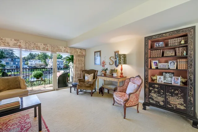 a living room with furniture a rug and a large window