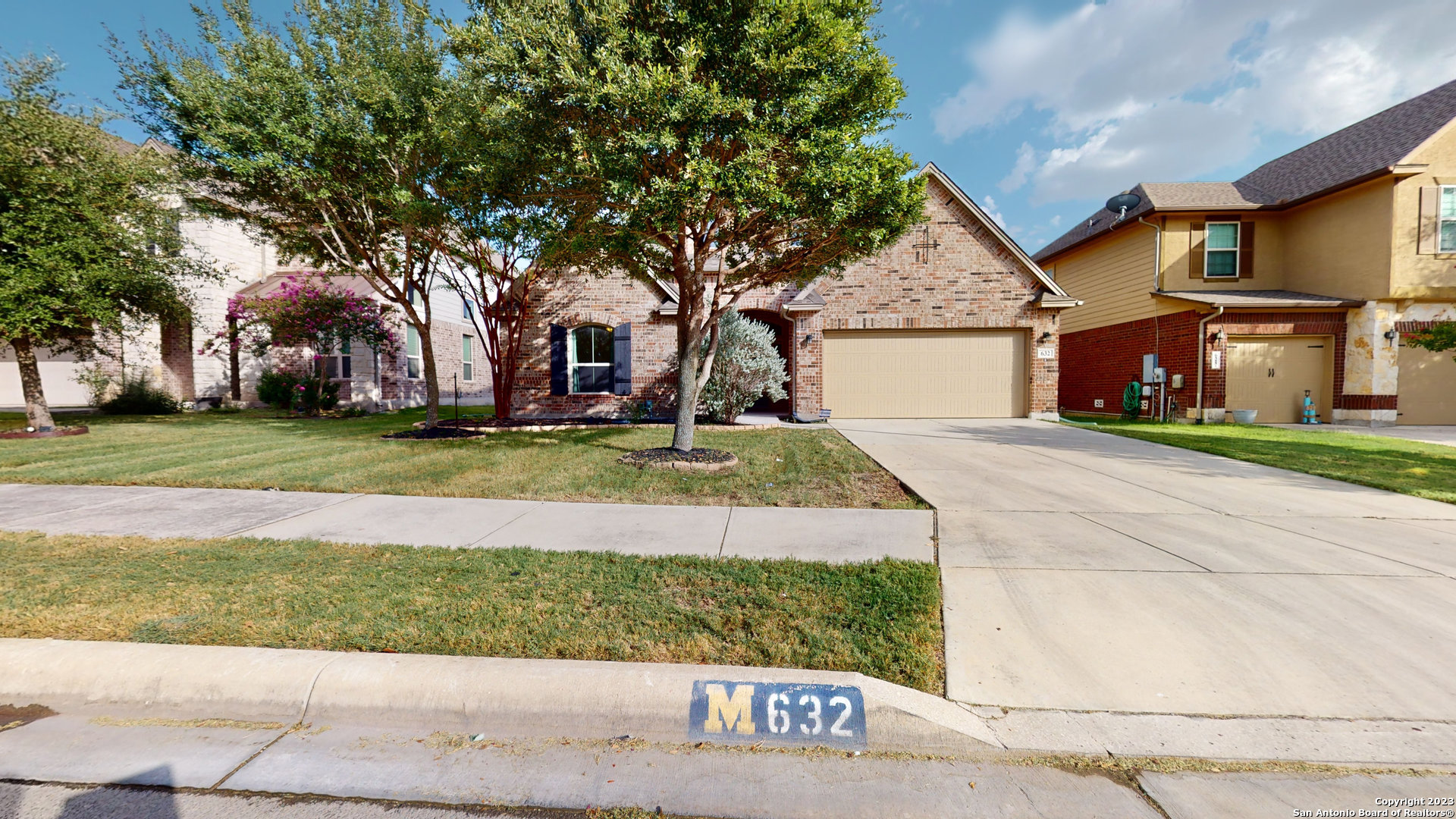 a view of a house with a yard and garage
