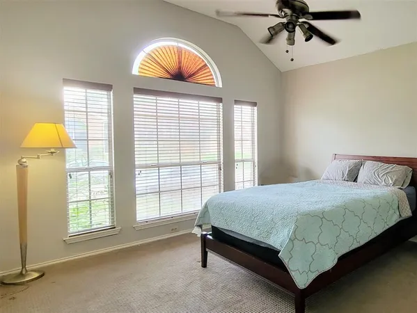a bedroom with a bed and a window