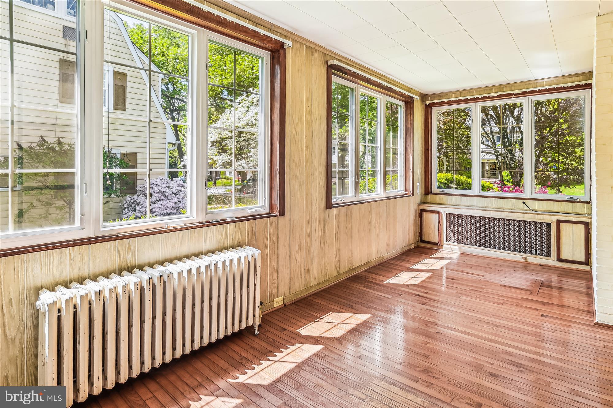 6211 Pinehurst Road Baltimore, MD 21212 - Photo 21 of 37 a view of an empty room with wooden floor and a window