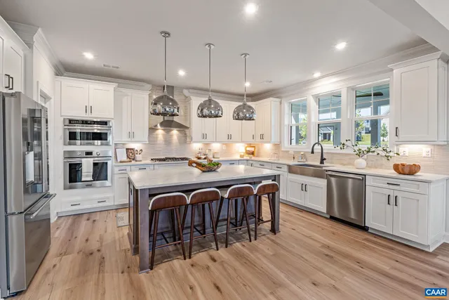 a view of a kitchen with wooden floor and electronic appliances