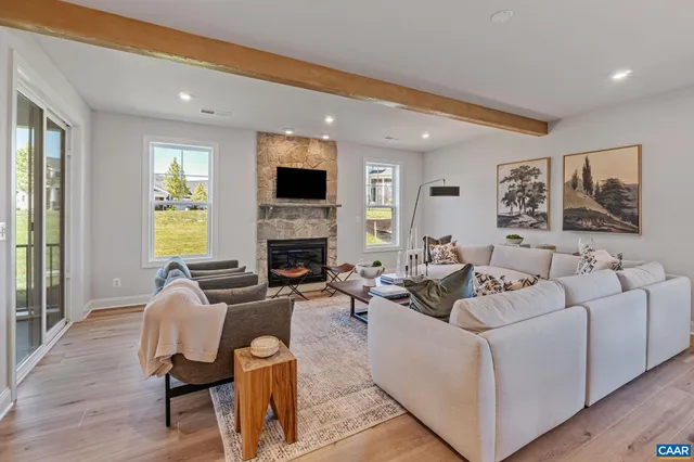 a living room with furniture and floor to ceiling windows